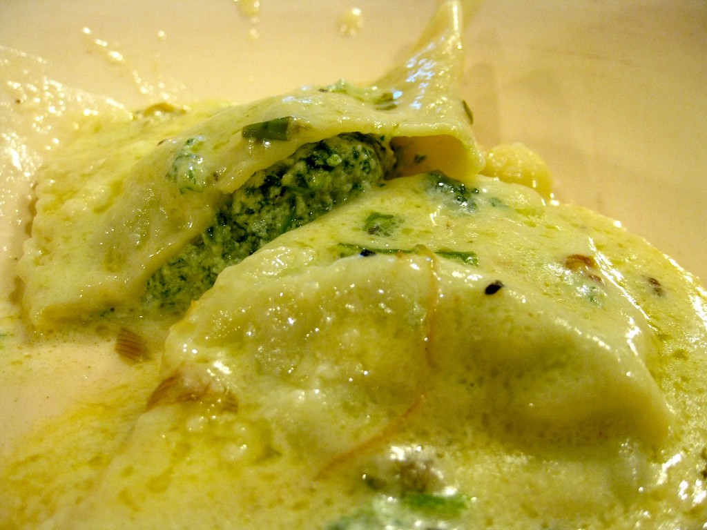 handfolded spinach ricotta ravioli in cream sauce